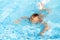 Child learn to swim, dive in blue pool with fun - jumping deep down underwater with splashes