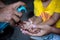 A child is learning how to clean hands with liquid cleaning gel.