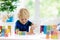 Child learning letters. Kid with wooden abc blocks