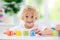 Child learning letters. Kid with wooden abc blocks