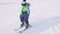 The child learns to ski with an instructor. Ski resort. Active sport