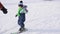 The child learns to ski with an instructor. Ski resort. Active sport