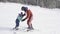 The child learns to ski with an instructor. Ski resort. Active sport