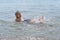 The child learns to swim. Happy child swims in the sea. Holidays in Greece