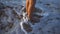 Child legs standing at the surf with flowing water