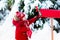 Child with letter to Santa at Christmas mail box in snow