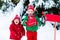 Child with letter to Santa at Christmas mail box in snow