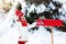 Child with letter to Santa at Christmas mail box in snow