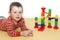 the child lies next to an educational toy  a maze for a ball. Cognitive  interesting  children\\\'s game that develops logical