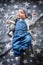 The child lies on a star blanket. Cute newborn baby girl lying in bed. Owl child sleeping on a blue blanket with stars. in