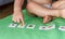 Child lining up toys on the floor at home. Kids education concept