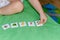 Child lining up toys on the floor at home. Kids education concept or  Stereotypical alignment of subjects is a sign of autism