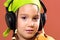 Child listening music in headphones