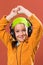 Child listening music in headphones