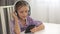 Child Listening Music at Headphones, School Girl using Smartphone in Kitchen 4K