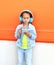Child listens to music in headphones and using smartphone