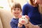 Child little girl arm putting coins into piggybank