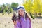 Child little girl holding pine cone in winter fall