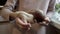 A child, a little girl, holds a huge live snail - a pet - in her hands at home and shows it to the camera. Close-up