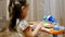 Child little girl playing on a toy piano