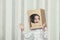 Child little girls playing astronaut in a cardboard helmet portrait