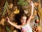 Child long hair play with dry leaves. Autumn coziness is just around. Child playful mood hold leaves. Kid cute girl play