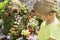 Child looking at fairy garden in a flower pot outdoors