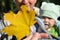 Child looking at the yellow maple leaf in mother`s hand