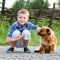 Child lovingly embraces his pet dog. Best friends. Outdoor