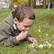 Child lying on grass in spring