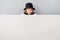 Child magician hiding behind banner blank