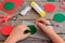 Child makes Christmas balls out of cardboard. Child draws a ball on a cardboard with a template and a pencil. Step. Stationery