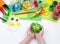 The child makes a craft toy from foam plastic tortoise. Material for creativity and education