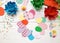 The child makes crafts with his own hands for the Easter. Colorful handmade from multi-colored paper. Flowers, cardboard, eggs,