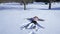 A child makes a snow angel