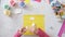 Child making card with Easter chick from colorful paper and cotton pad. Handmade. A project of children`s creativity, handicrafts,