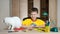 Child making Christmas decorations with cat on the table. Make christmas decoration with your own hands.