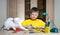 Child making Christmas decorations with cat on the table. Make christmas decoration with your own hands.