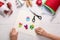 Child making felt Christmas toys at wooden table