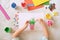 Child making homemade greeting card. little girl making vase with flowers from paper and clay, plasticine as gift for Mothers day