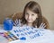 Child making homemade greeting card. Painted hand. A little girl paints a heart on a homemade greeting card