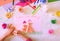 Child making homemade greeting card from paper and clay, plasticine as gift for Mothers day, Birthday or Valentines day . Arts