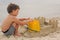 Child making sand castles at the beach