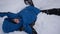 Child making a snow angel in slowmotion