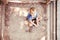 Child marginalized by his friends plays alone with sad eyes in a playground