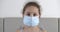 Child in a medical mask. Pandemic, covid - 19. Portrait Cute Baby Girl in a protective medical mask, with a sad