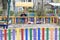 Child in medical mask and with phone on colored playground during quarantine