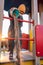 A child in a medical mask plays on the playground and pours sand from a bucket during the coronavirus and Covid - 19 pandemic