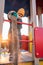 A child in a medical mask plays on the playground and pours sand from a bucket during the coronavirus and Covid - 19 pandemic