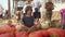 Child meditates in lotus position, sitting with orange pumpkins, farmers market.